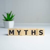 Wooden blocks spelling out myths with plant