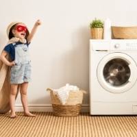 Washing machine and boy dressed as a superhero